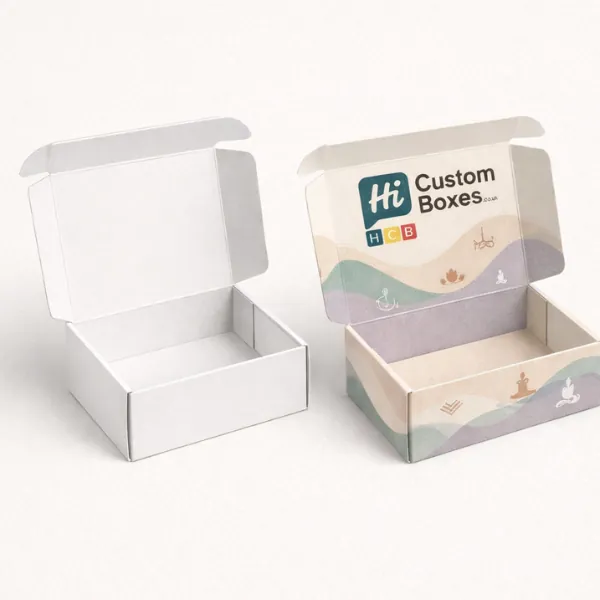 A pair of open cardboard boxes showing a clean white interior and a pastel-coloured exterior-